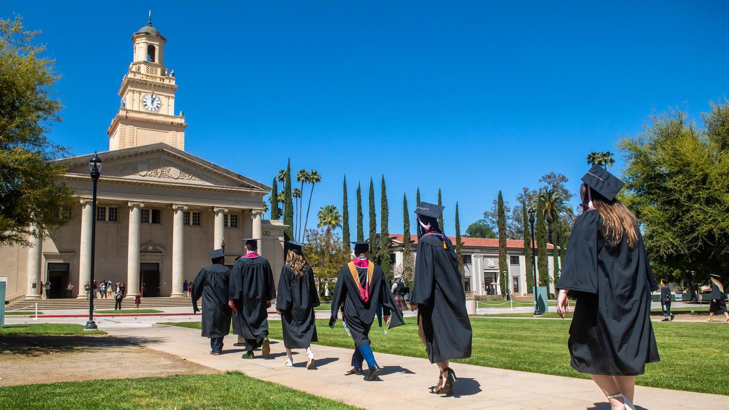 Students walking toward the Memorial Chapel during graduation.